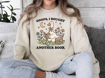 A Gildan 18000 sweatshirt with the saying "oops i bought another book"
