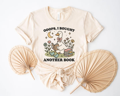 A bella canvas 3001 shirt with the saying "ooops I bought another book"