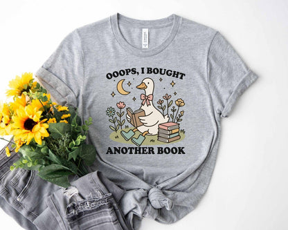 A bella canvas 3001 shirt with the saying "ooops I bought another book"