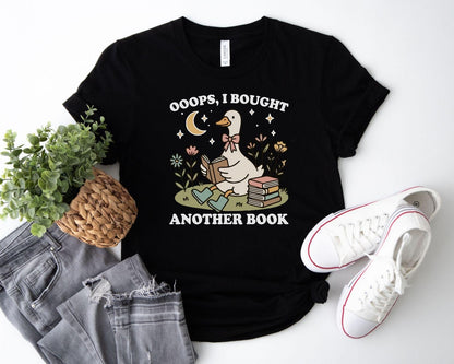 A bella canvas 3001 shirt with the saying "ooops I bought another book"