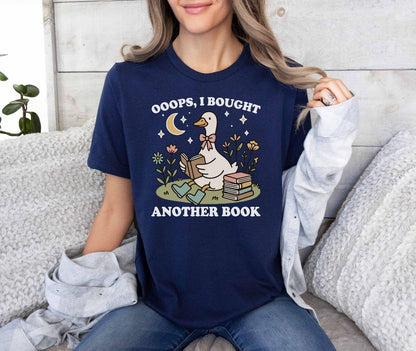 A bella canvas 3001 shirt with the saying "ooops I bought another book"