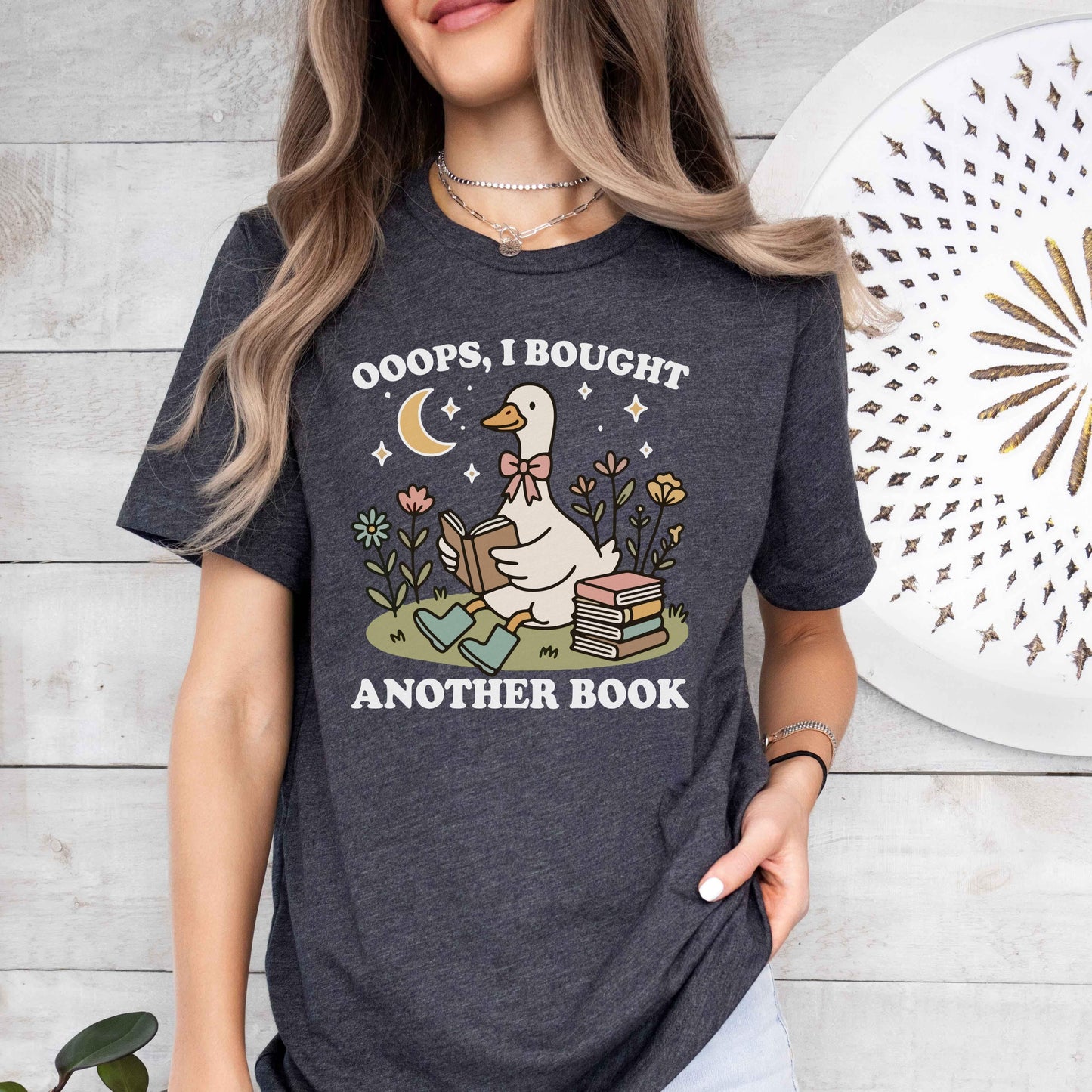 A bella canvas 3001 shirt with the saying "ooops I bought another book"