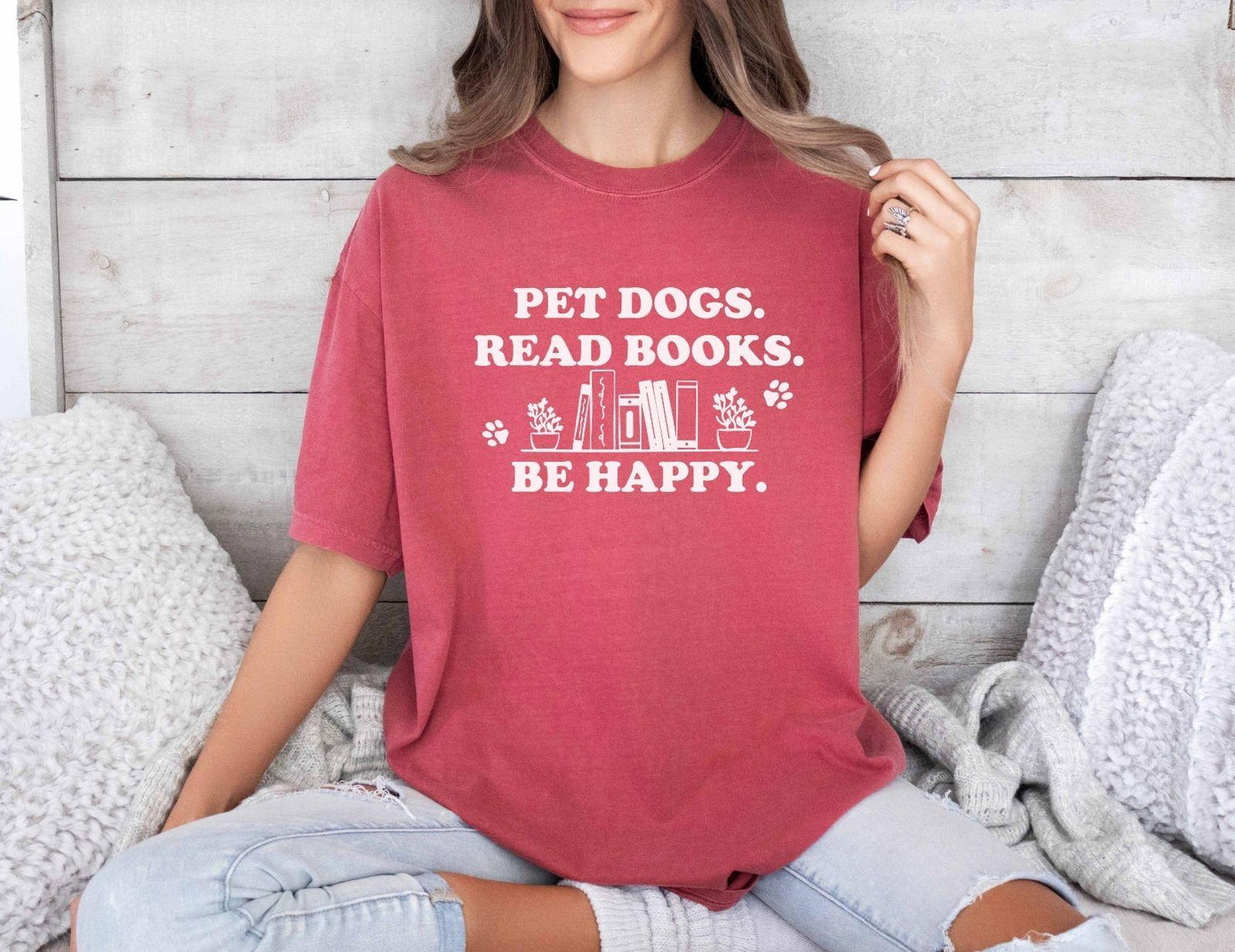 A comfort colors shirt with the saying "Pet dogs read books be happy"