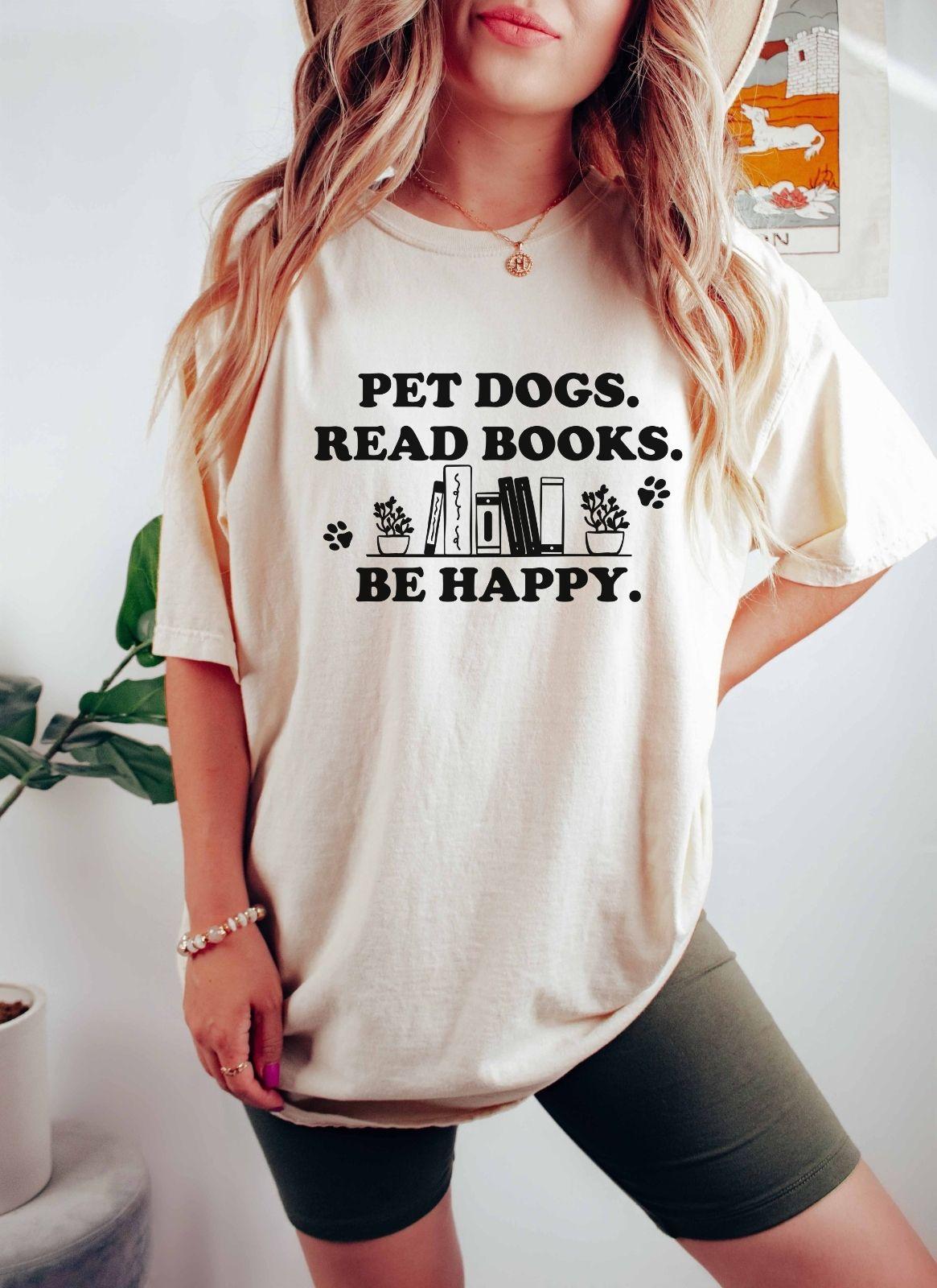 A comfort colors shirt with the saying "Pet dogs read books be happy"