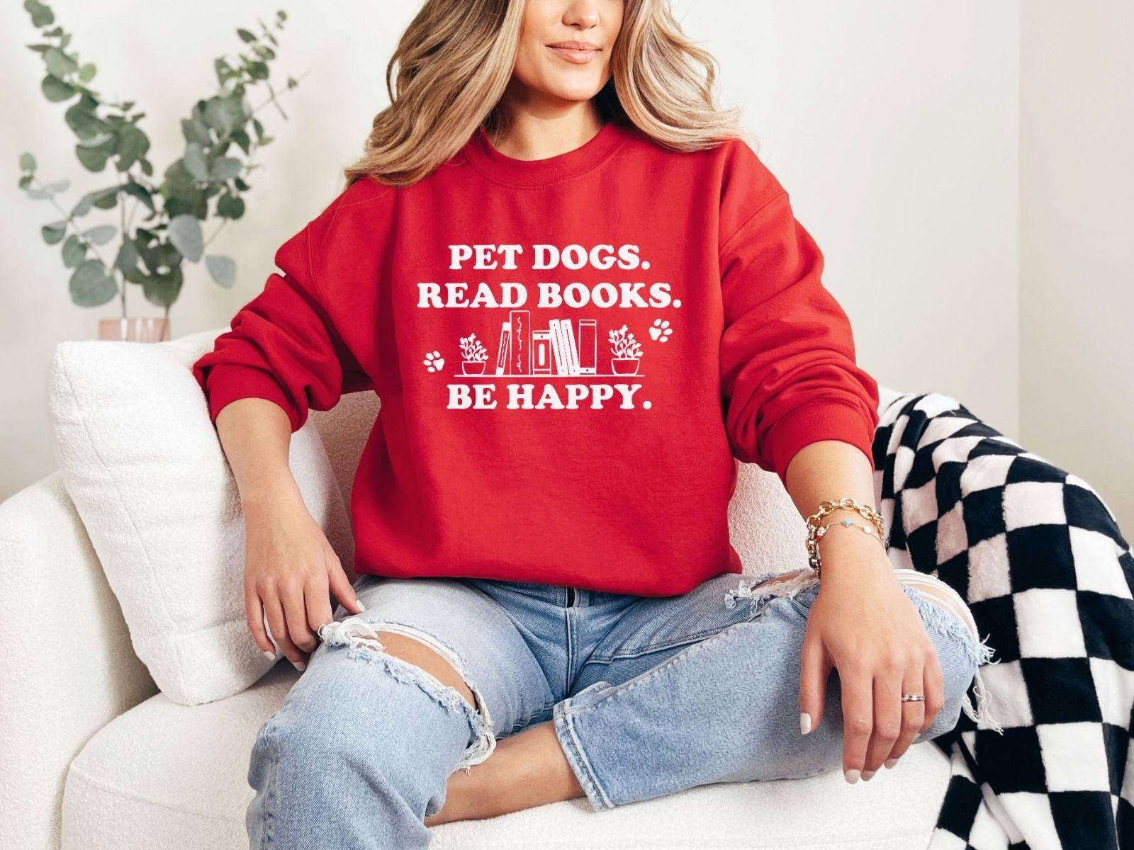 A gildan 18000 sweatshirt with the saying "Pet dogs read books be happy"