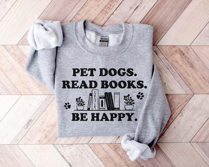 A gildan 18000 sweatshirt with the saying "Pet dogs read books be happy"