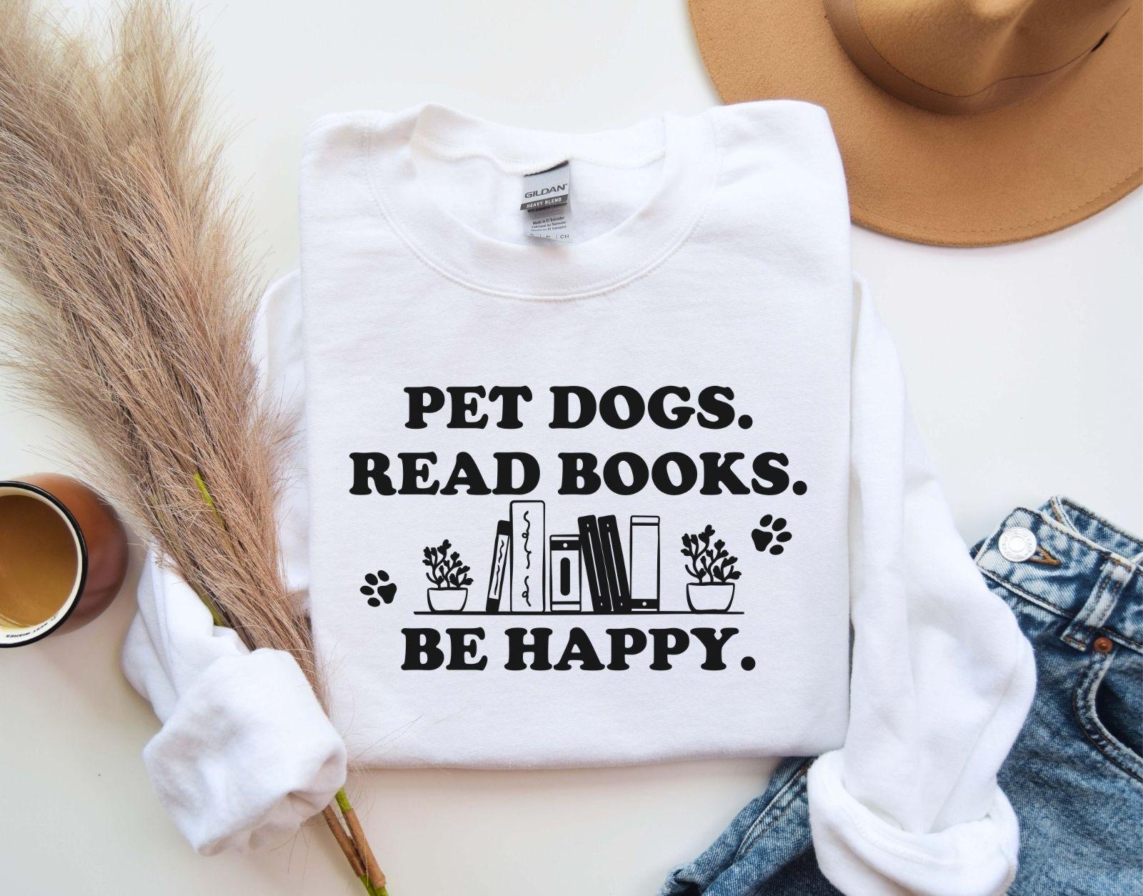 A gildan 18000 sweatshirt with the saying "Pet dogs read books be happy"