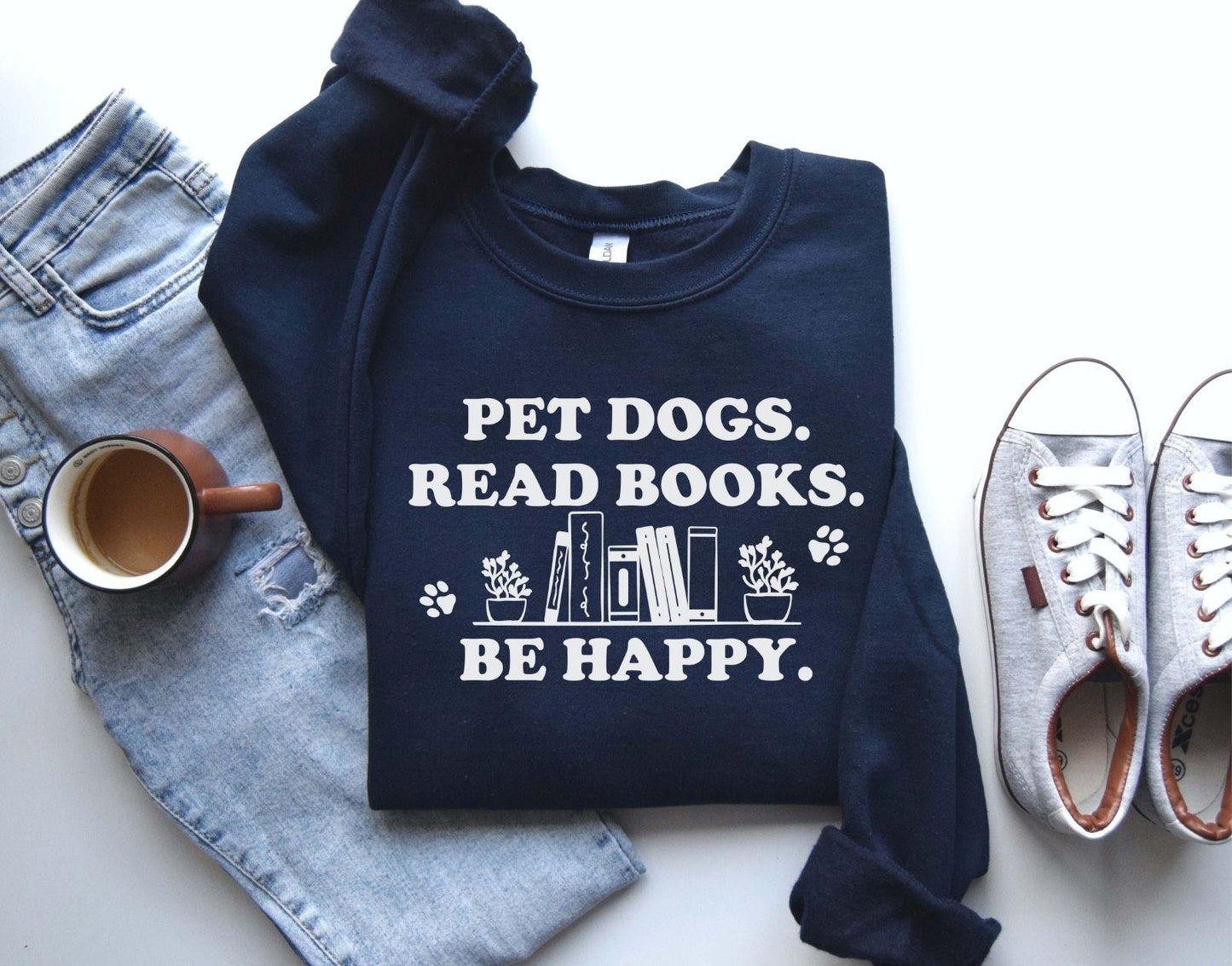 A gildan 18000 sweatshirt with the saying "Pet dogs read books be happy"