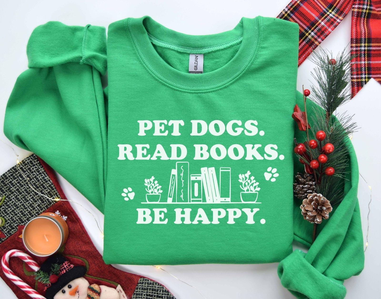 A gildan 18000 sweatshirt with the saying "Pet dogs read books be happy"