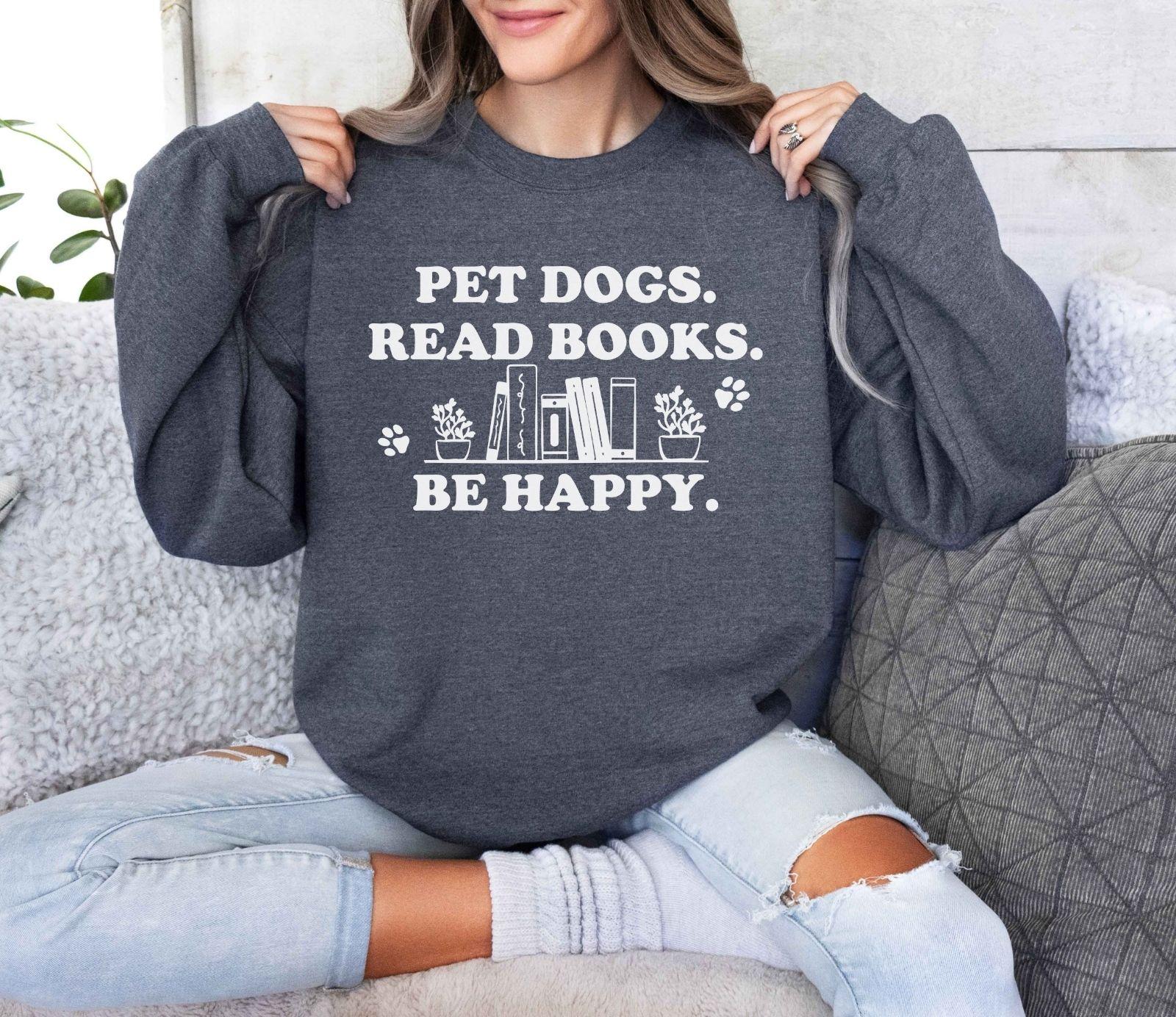 A gildan 18000 sweatshirt with the saying "Pet dogs read books be happy"