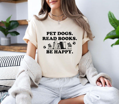 A gildan 18000 sweatshirt with the saying "Pet dogs read books be happy"