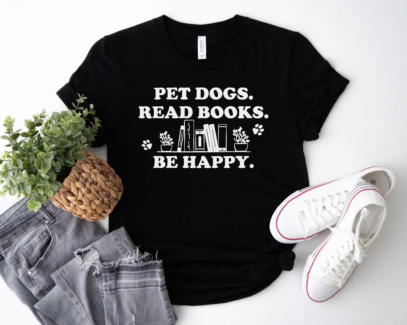 A gildan 18000 sweatshirt with the saying "Pet dogs read books be happy"