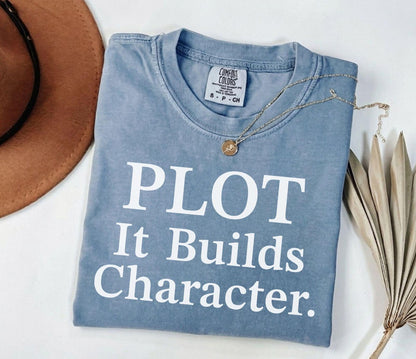 A comfort colors® shirt with the saying "Plot it builds character"