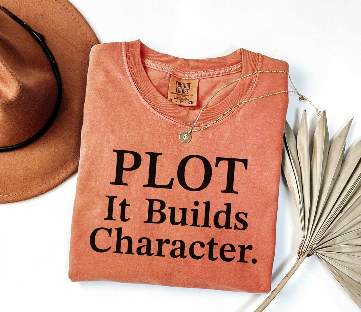 A comfort colors® shirt with the saying "Plot it builds character"