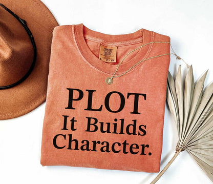 A comfort colors® shirt with the saying "Plot it builds character"