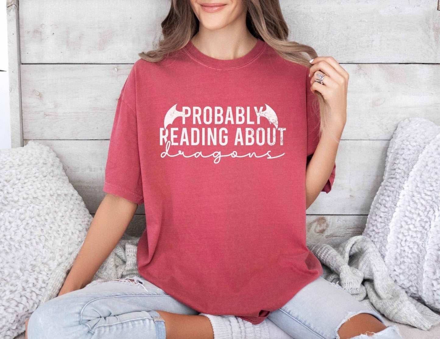 A comfort colors® shirt with the saying "Probably reading about dragons"