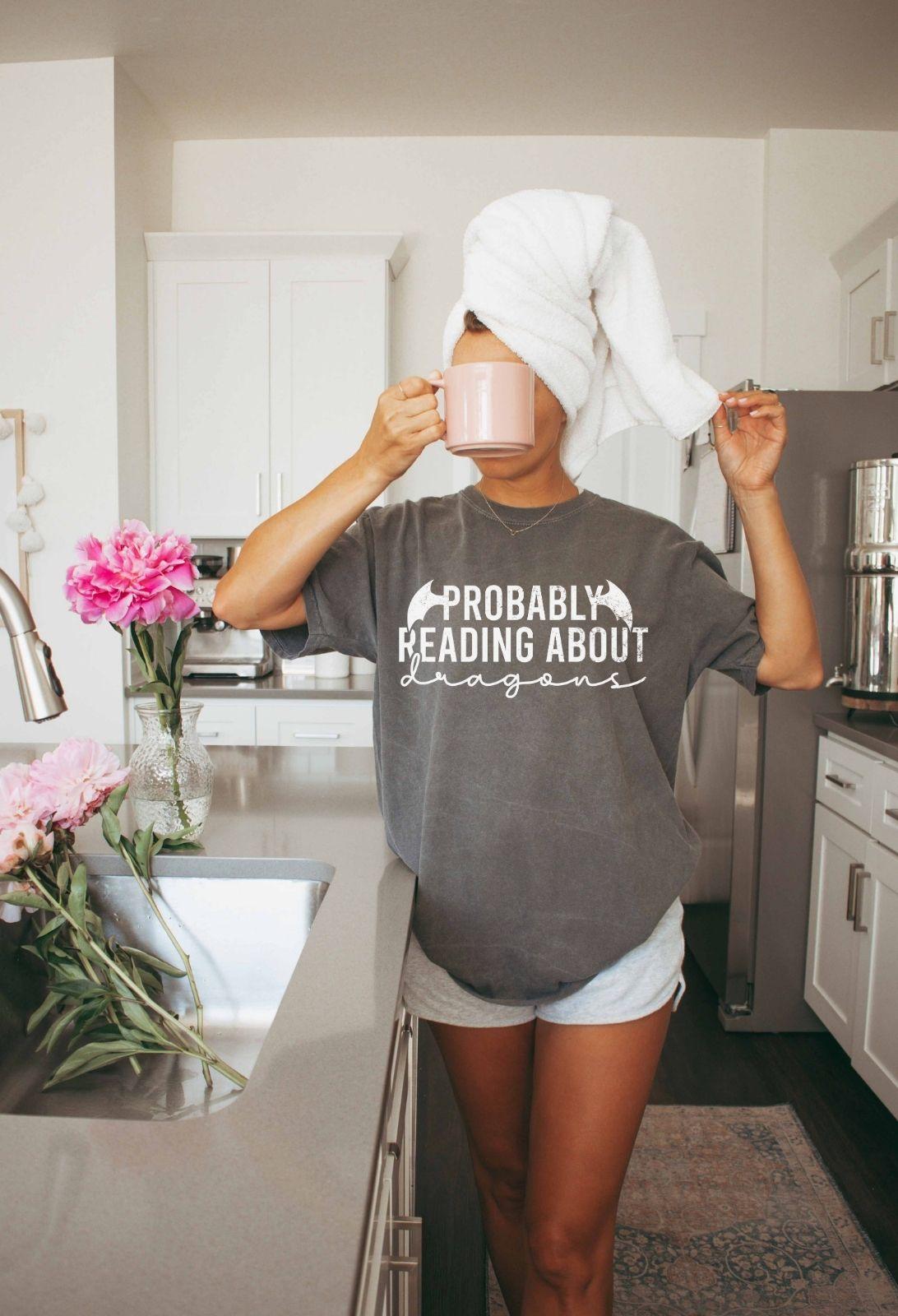 A comfort colors® shirt with the saying "Probably reading about dragons"