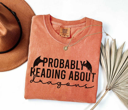 A comfort colors® shirt with the saying "Probably reading about dragons"