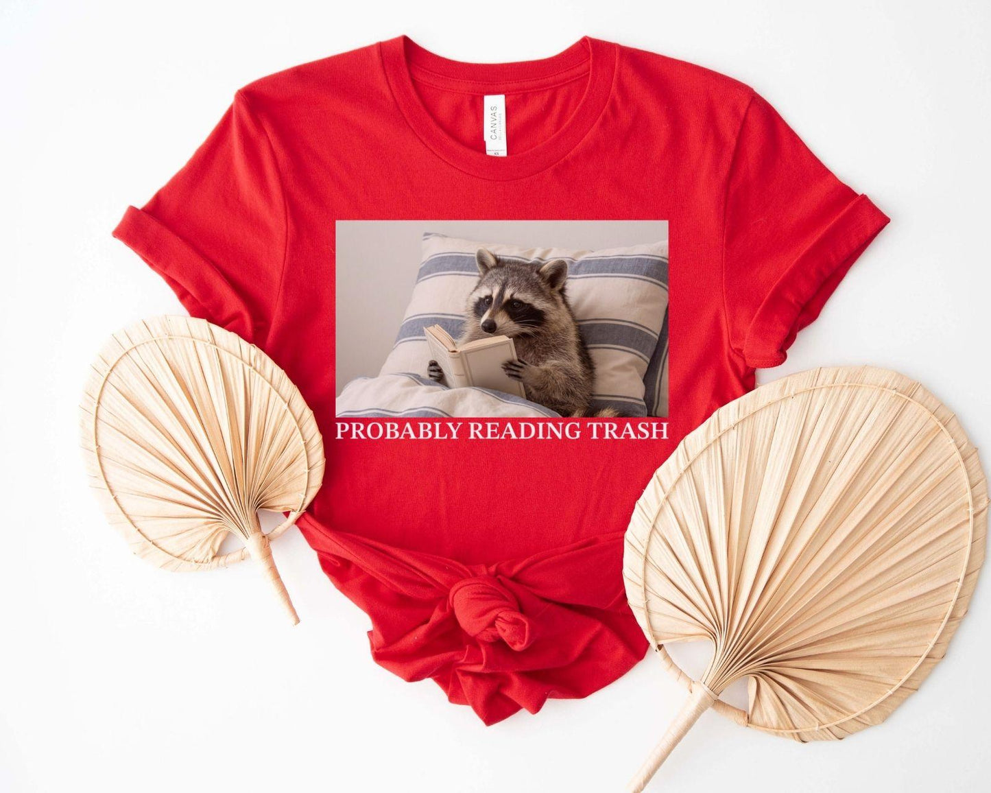 A bella canvas 3001 shirt with the saying "Probably reading trash"
