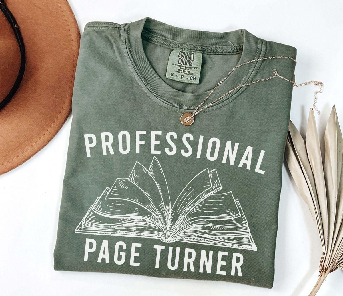 A comfort colors® shirt with the saying "Professional page turner"