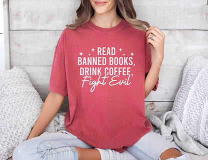 A comfort colors shirt with the saying "Read banned books drink coffee fight evil"