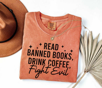 A comfort colors shirt with the saying "Read banned books drink coffee fight evil"