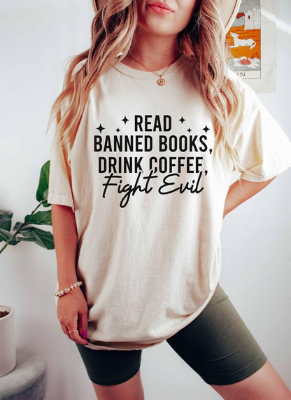 A comfort colors shirt with the saying "Read banned books drink coffee fight evil"