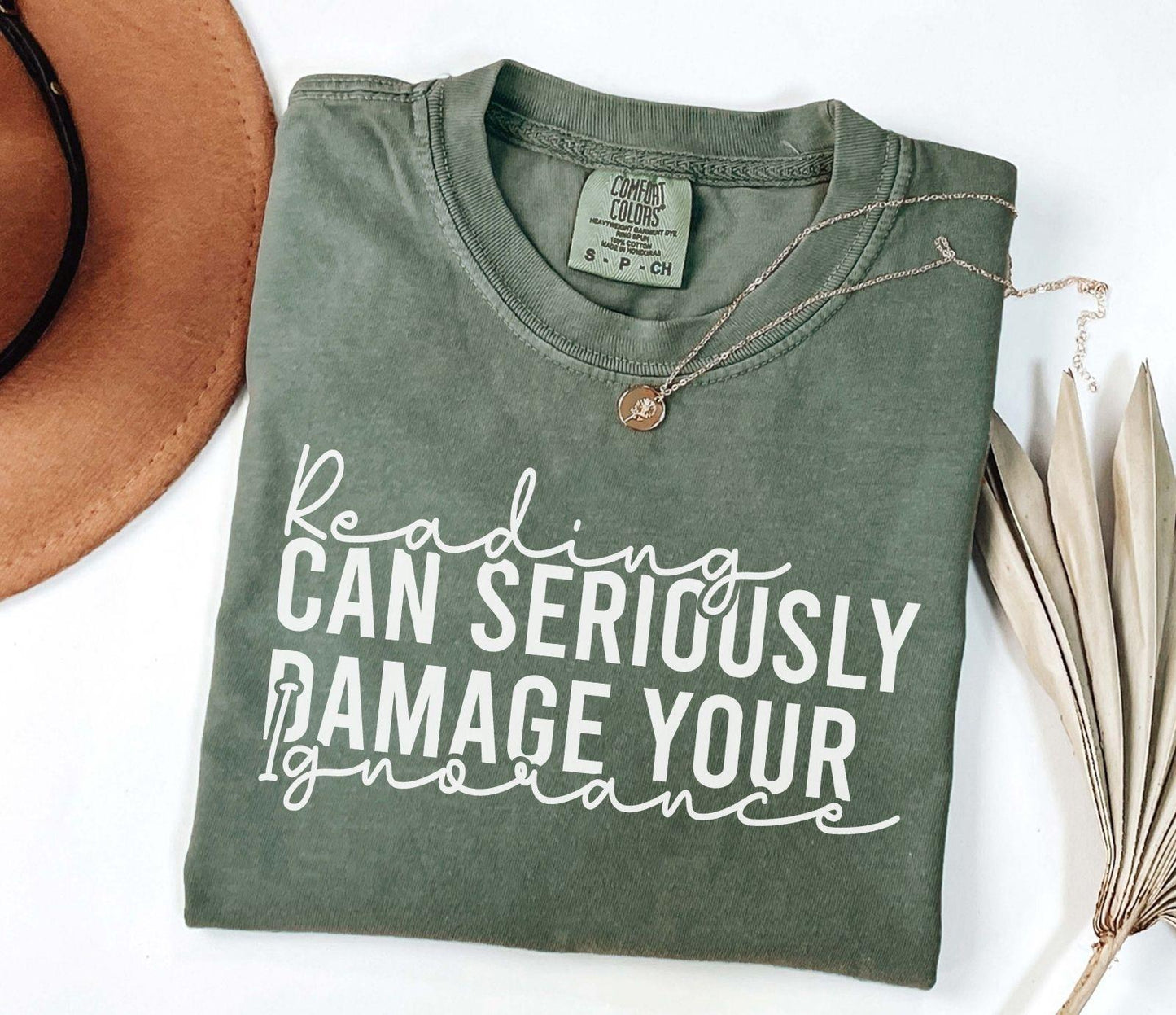 A comfort colors® shirt with the saying "Reading can seriously damage your ignorance"