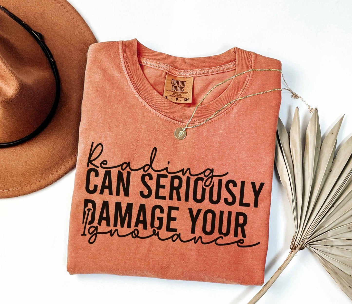 A comfort colors® shirt with the saying "Reading can seriously damage your ignorance"