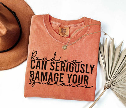 A comfort colors® shirt with the saying "Reading can seriously damage your ignorance"