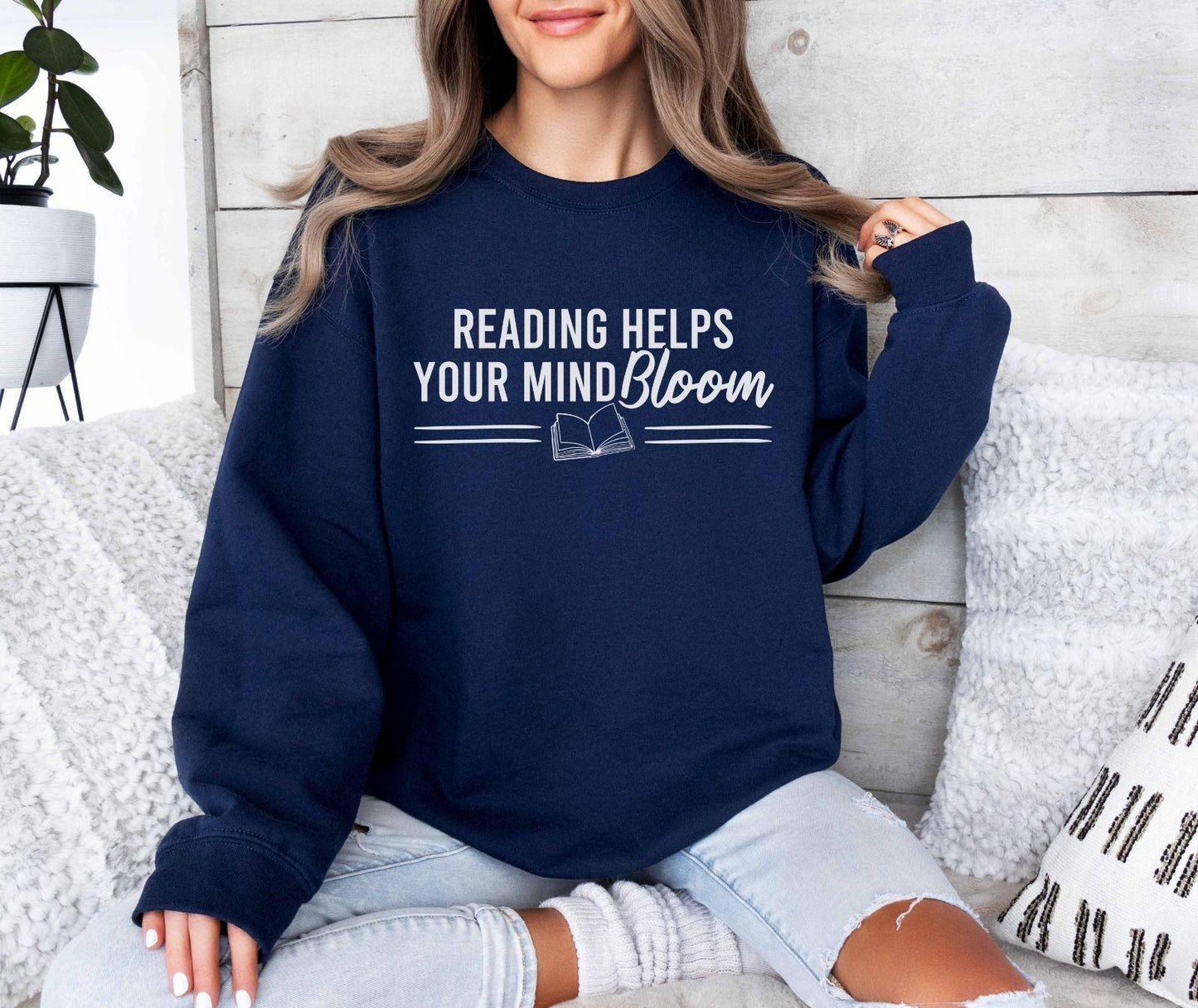 A Gildan 18000 sweatshirt with the saying "reading helps your mind bloom"