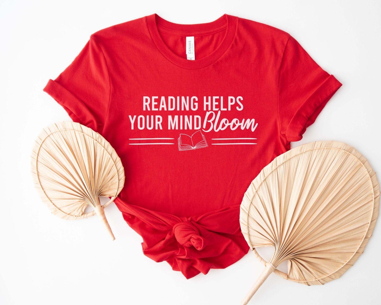A comfort colors® shirt with the saying "reading helps your mind bloom"