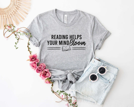 A comfort colors® shirt with the saying "reading helps your mind bloom"