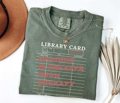 A comfort colors® shirt with the saying "reading is cheaper than therapy"