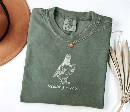 A comfort colors® shirt with the saying "reading is coo"
