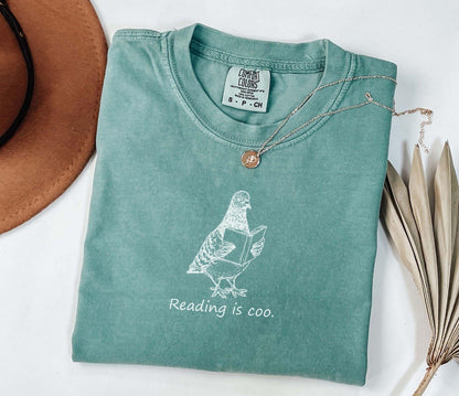 A comfort colors® shirt with the saying "reading is coo"
