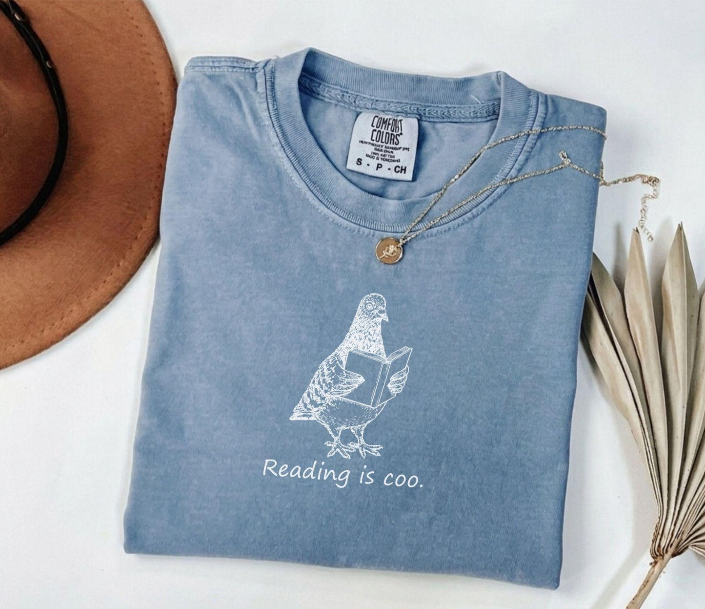 A comfort colors® shirt with the saying "reading is coo"