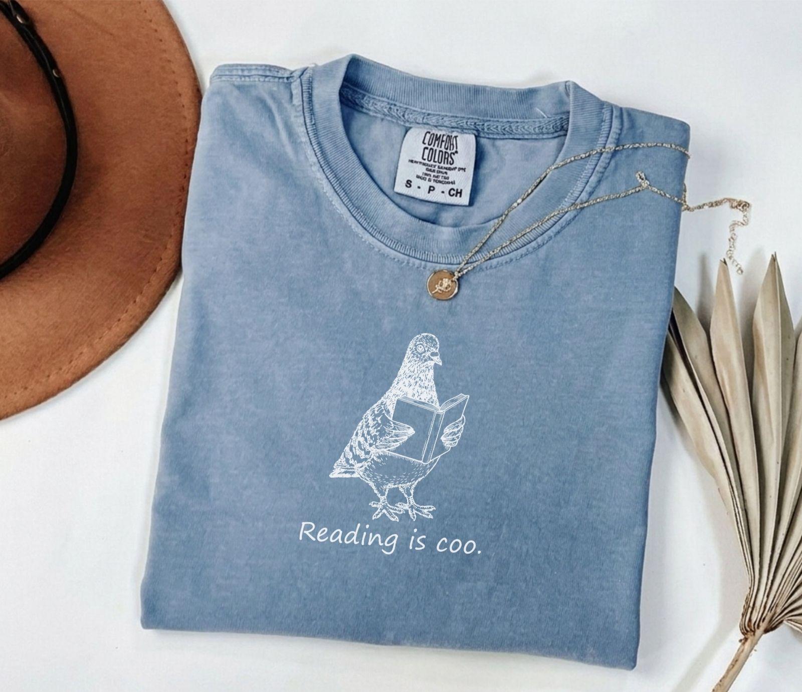 A comfort colors® shirt with the saying "reading is coo"