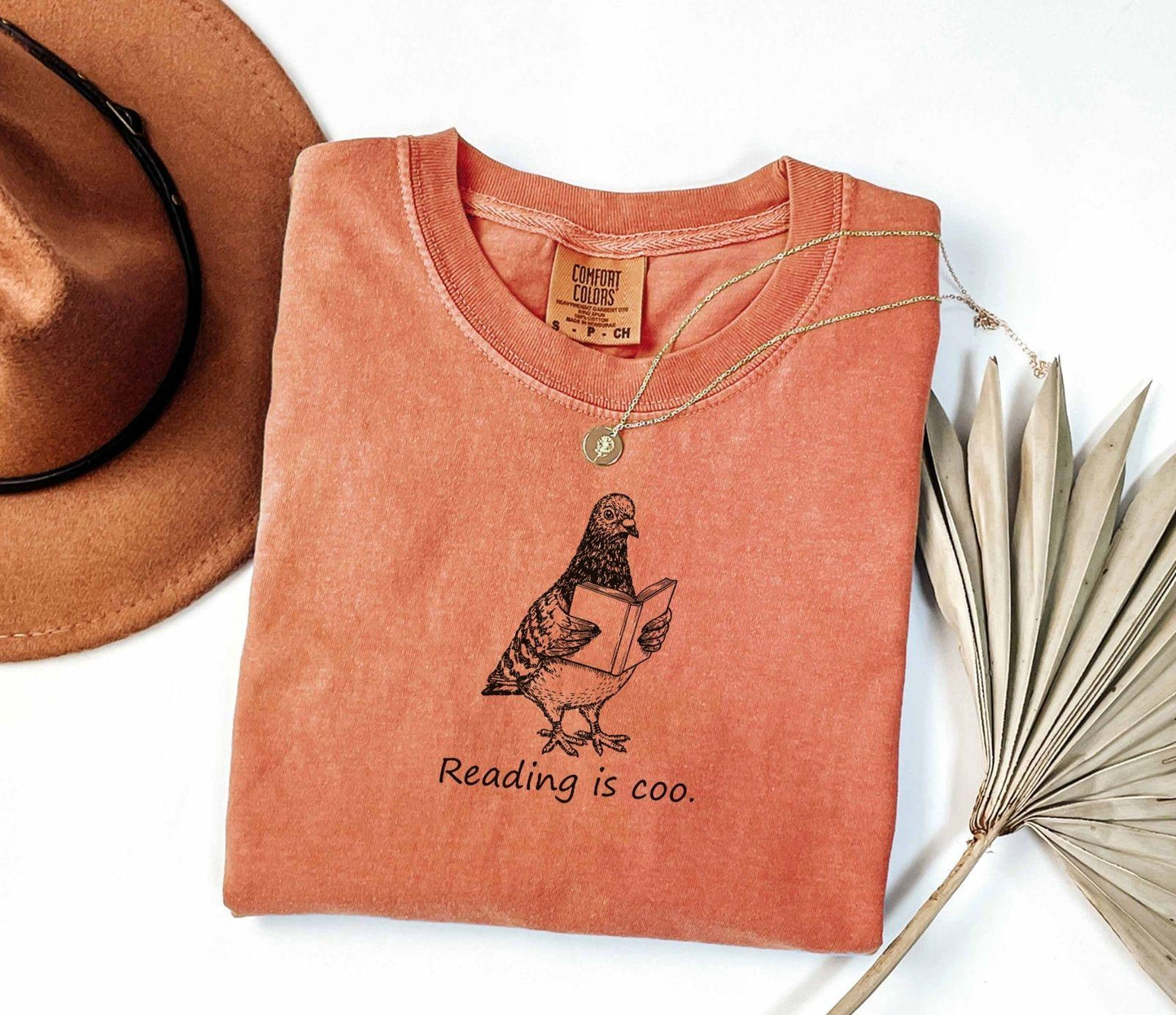 A comfort colors® shirt with the saying "reading is coo"