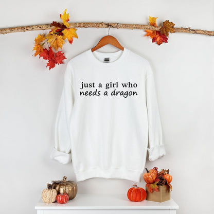 A Gildan 18000 sweatshirt with the saying "just a girl who needs a dragon"