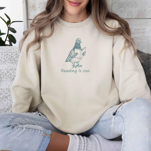 A Gildan 18000 sweatshirt with the saying "reading is coo"