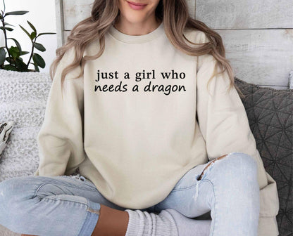 A Gildan 18000 sweatshirt with the saying "just a girl who needs a dragon"