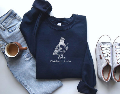 A Gildan 18000 sweatshirt with the saying "reading is coo"