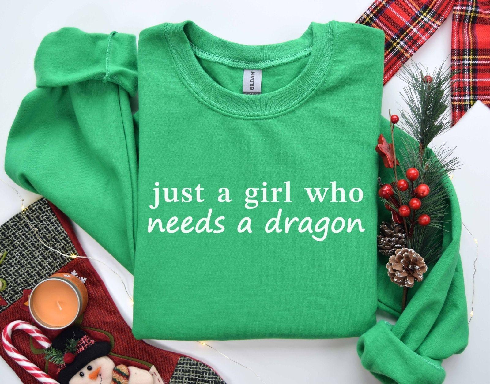 A Gildan 18000 sweatshirt with the saying "just a girl who needs a dragon"