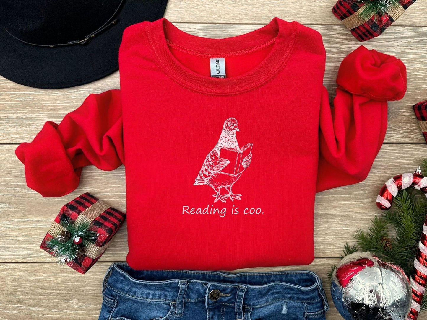 A Gildan 18000 sweatshirt with the saying "reading is coo"