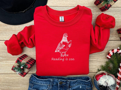 A Gildan 18000 sweatshirt with the saying "reading is coo"