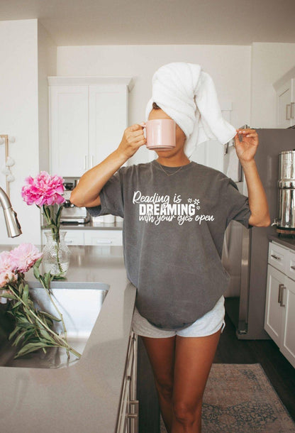 A comfort colors® shirt with the saying "Reading is dreaming with your eyes open"