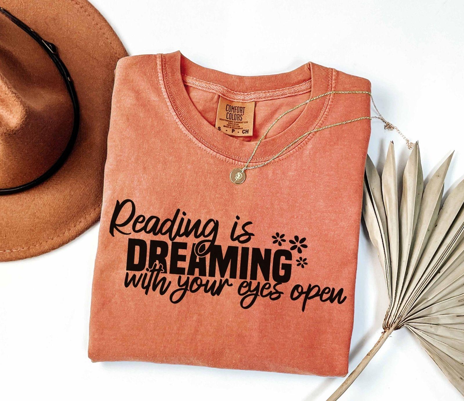 A comfort colors® shirt with the saying "Reading is dreaming with your eyes open"