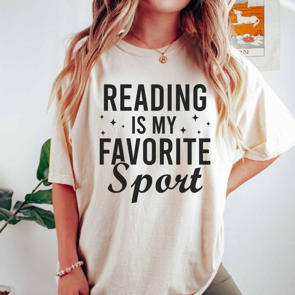 A comfort colors® shirt with the saying "reading is my favorite sport"