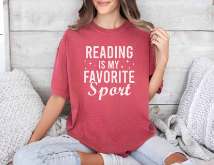 A comfort colors® shirt with the saying "Reading is my favorite sport"